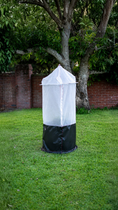 Load image into Gallery viewer, Tree Defender 6' Skirted Tree Defender. The white mesh cover has a secured top and secured around the base.