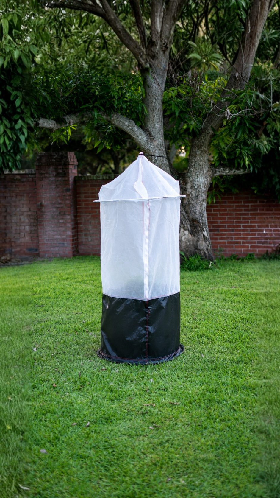 Tree Defender 6' Skirted Tree Defender. The white mesh cover has a secured top and secured around the base.
